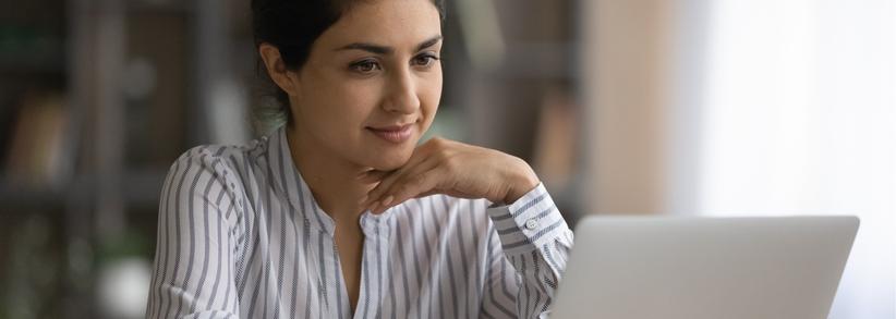 Woman reading interesting content on laptop