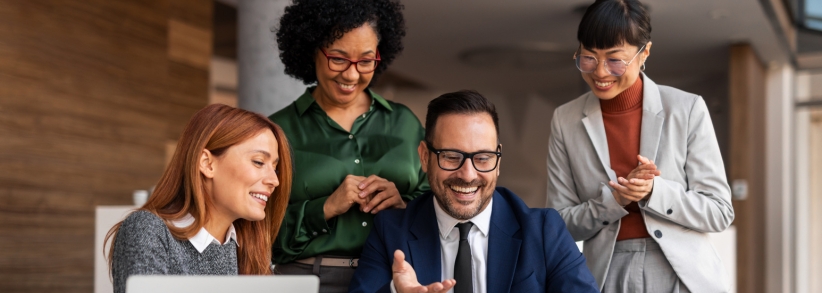 Marketing agency working together happily looking at one computer